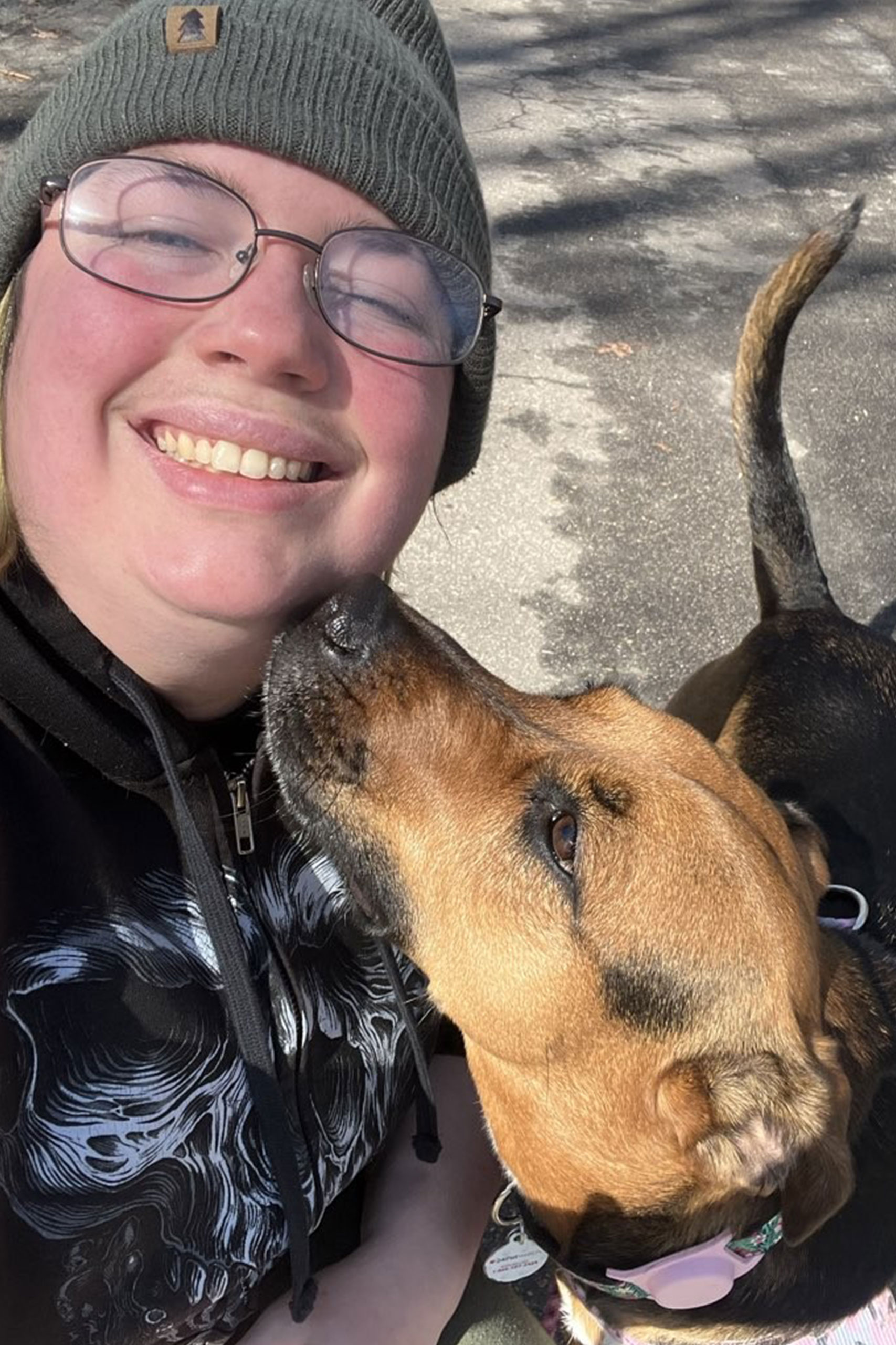 Cam from Barks and Recreation walking a dog.